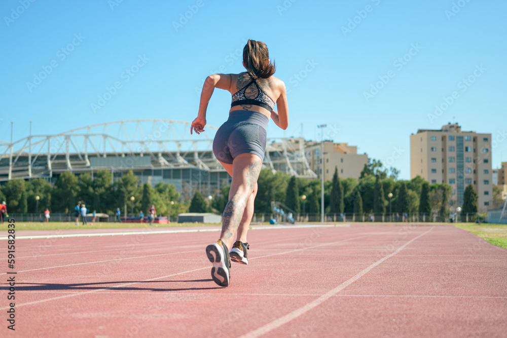 Fototapeta premium Fitness runner woman on running track working out