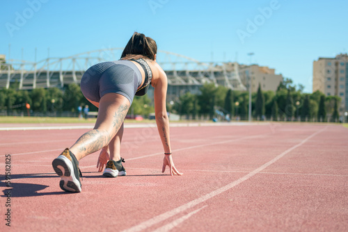 Fitness runner woman on running track working out