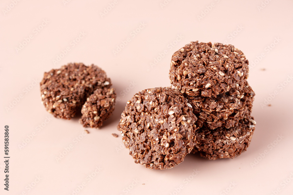 cookies made of cereals and chocolate on a beige background cookies made of cereals and chocolate on a beige background
