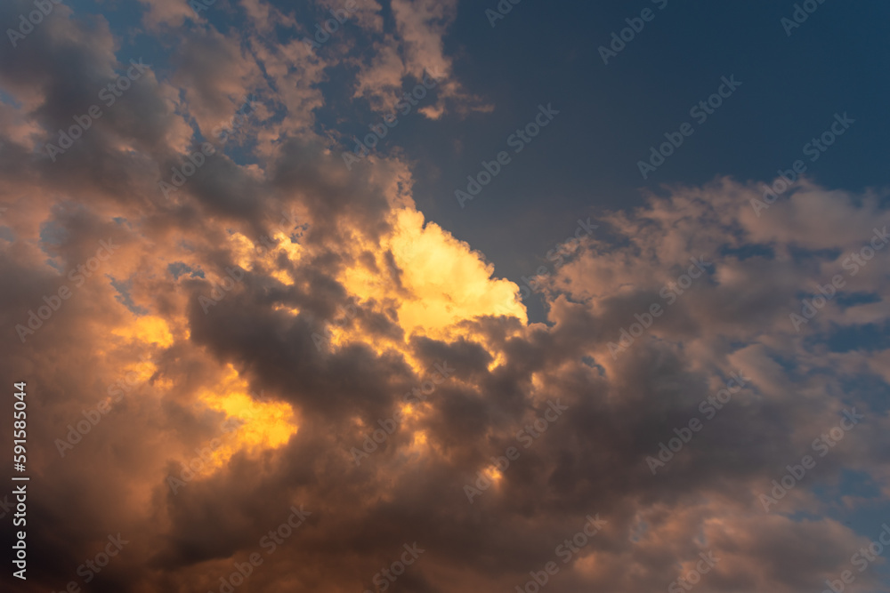 Fototapeta premium Perfect background Bright golden orange clouds illuminated by sunlight. Summer evening bright sky