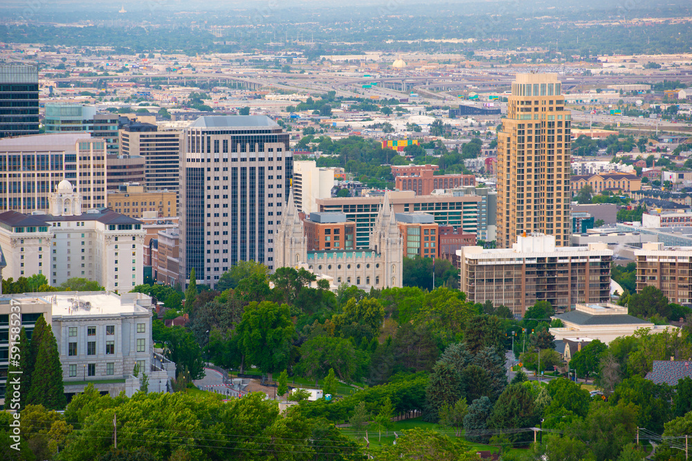 Fototapeta premium Salt Lake Utah Temple, the church of Jesus Christ of Latter Day Saints at sunrise with Salt Lake City modern skyline at the background, Salt Lake City, Utah UT, USA. 