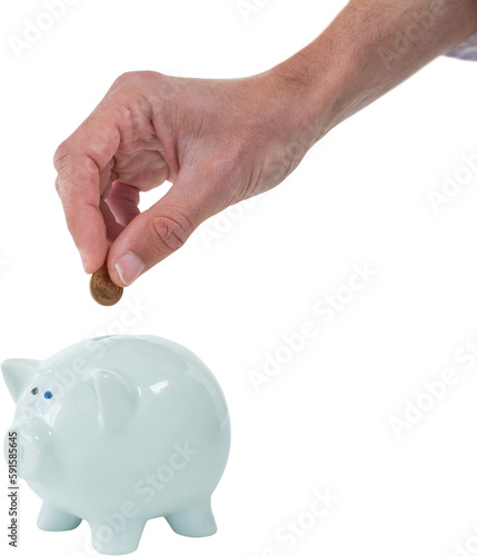 Cropped hand of person inserting coin in piggy bank