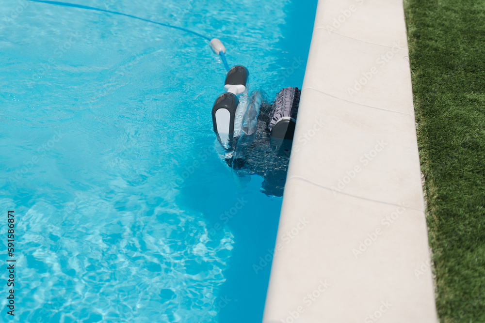 Naklejka premium Robot vacuum cleaner for the pool cleans the outdoor pool