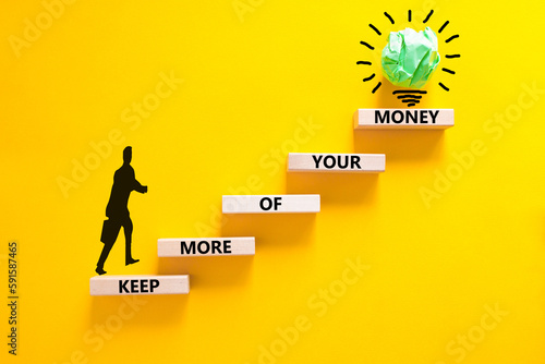 Keep more of your money symbol. Concept words Keep more of your money on wooden block. Beautiful yellow table yellow background. Businessman icon. Business keep more of your money concept. Copy space.
