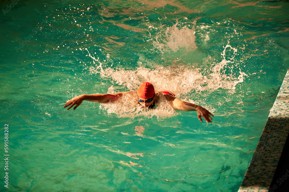 Swimming male swimmer swimming breaststroke. Close up portrait of man