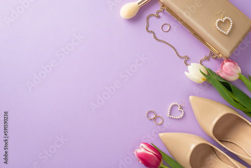 Stylish Mother's day concept. Top view of high-heels, handbag, tulips, makeup brush, earrings on violet background with copy space for greeting text
