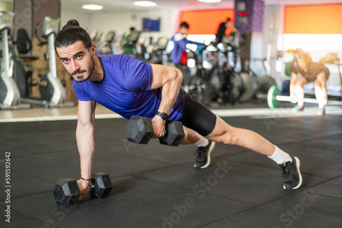 Workout And Dumbbell Push Up At Gym For Muscle  Power Or Strength. Young Athlete Man Exercises And Trains His Body To Keep Fit And Lead A Healthy Life