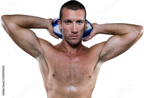 Handsome shirtless rugby player holding ball