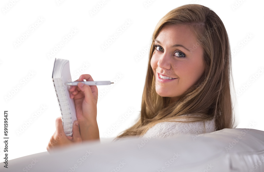Pretty blonde relaxing on the couch writing in notepad Pretty blonde relaxing on the couch writing in notepad