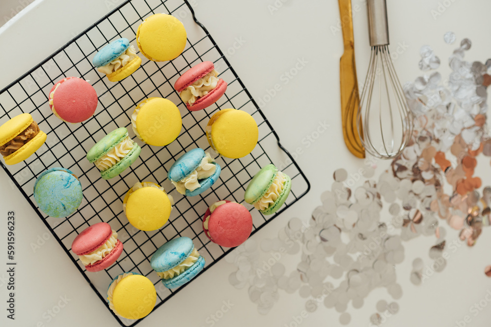 traditional french colorful macarons in a rows on a metal mesh traditional french colorful macarons in a rows on a metal mesh