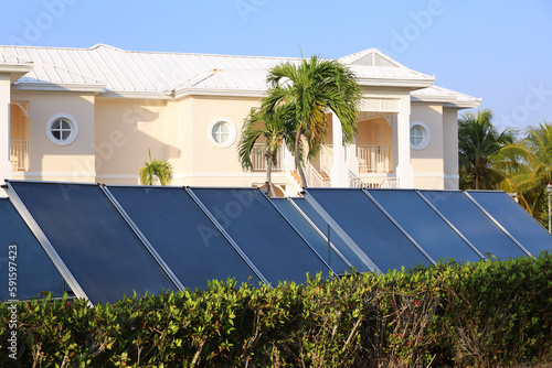 Photography Solar panels on background of villa and palm trees
