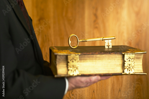 Man Holding Antique Book and Key photo