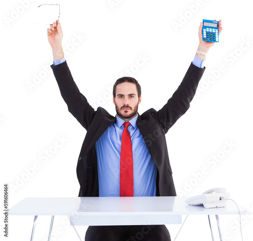 Businessman holding up reading glasses and calculator
