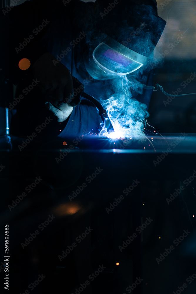 Man working on iron with grinder. Man at work. Sparkles and fire from grinder cutting. Grinder. Worker. Man working on iron with grinder. Man at work. Sparkles and fire from grinder cutting. Grinder. Worker.