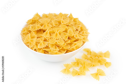 Farfalle in bowl and isolated on white background. Raw pasta spiral shape, ingredient for cook, traditonal italian cuisine.