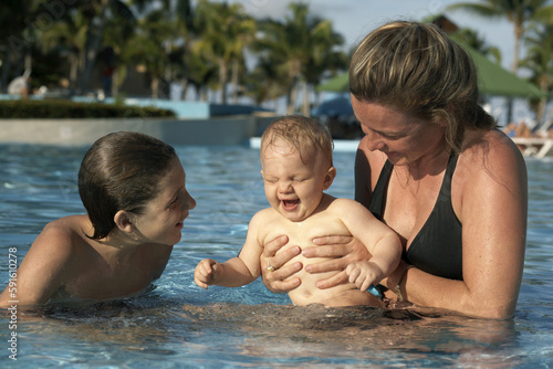 Mother with Sons in Swimming Pool, Cayo Coco, Cuba photo