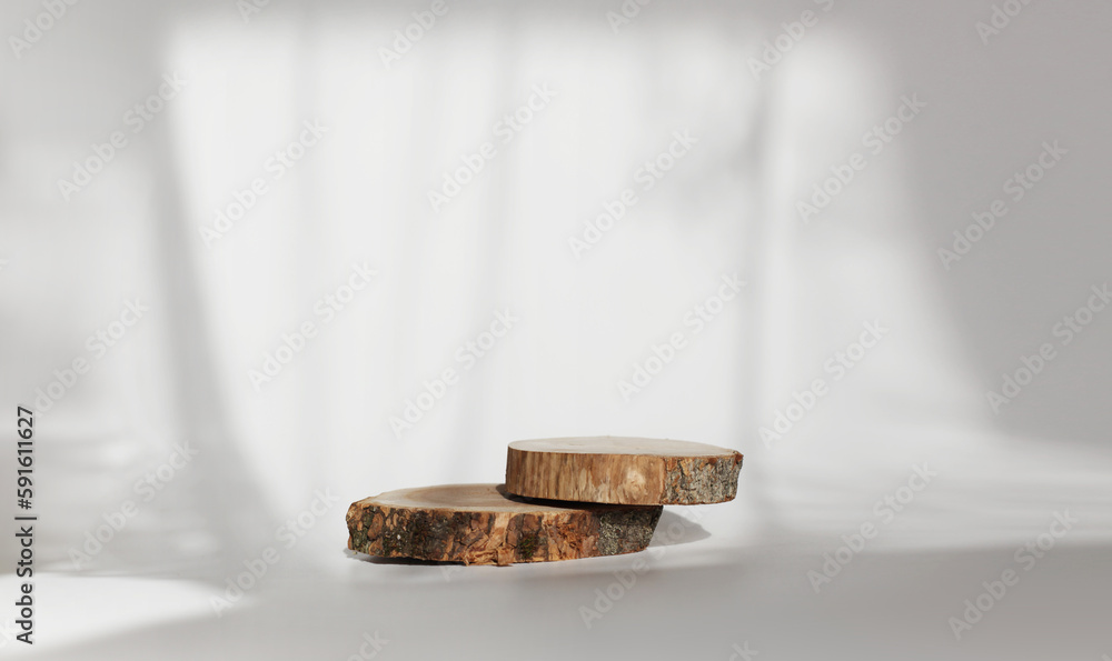 Wooden eco rustic pine tree wood circle disc platform podium on white light and shadow copy spase background. Minimal empty display product presentation scene. Wooden eco rustic pine tree wood circle disc platform podium on white light and shadow copy spase background. Minimal empty display product presentation scene.