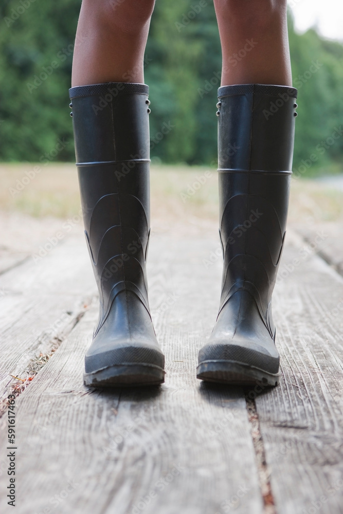Close-up of Woman Wearing Rubber Boots on Dock, Near Portland, Oregon, USA Close-up of Woman Wearing Rubber Boots on Dock, Near Portland, Oregon, USA