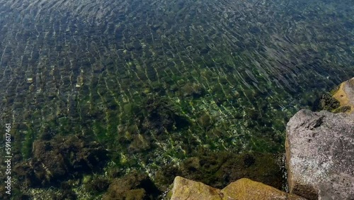 Small and Calm Waves on the Sea with a Few Rocks