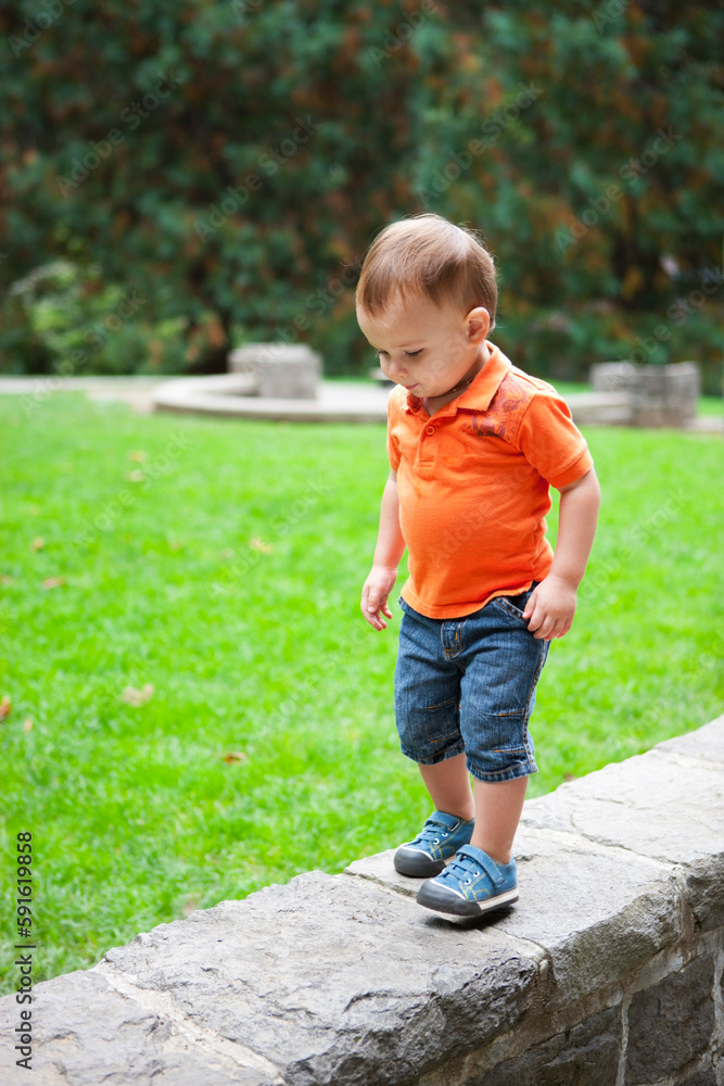 Boy Walking on Stone Wall, Washington Park, Portland, Oregon, USA Boy Walking on Stone Wall, Washington Park, Portland, Oregon, USA