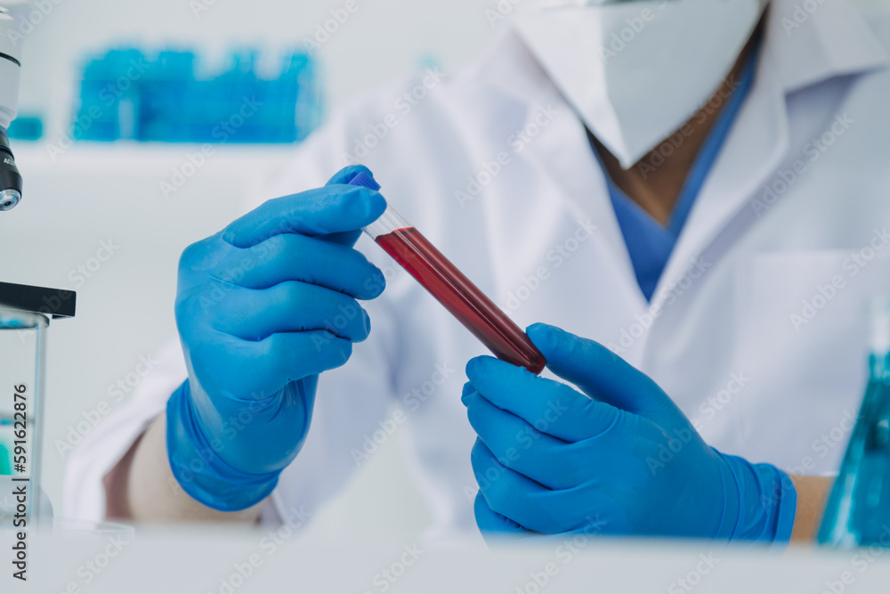 biochemical research scientist team working with microscope for coronavirus vaccine development in pharmaceutical research labolatory, selective focus biochemical research scientist team working with microscope for coronavirus vaccine development in pharmaceutical research labolatory, selective focus