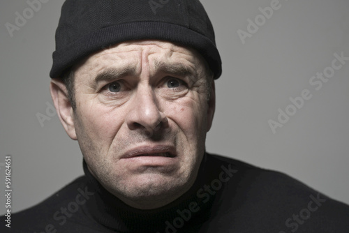 Man in Black Cap Looking Scared photo