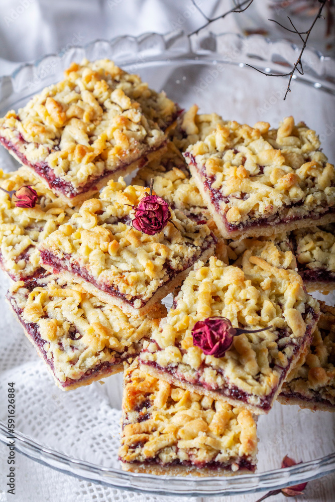 Streusel pie with currant and rose petal filling on a light background.