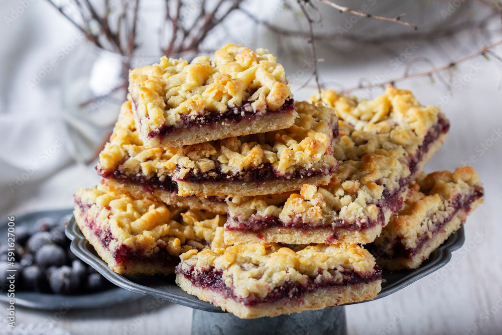 Streusel pie with currant and rose petal filling on a light background.