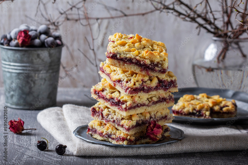 Streusel pie with currant and rose petal filling on a light background.