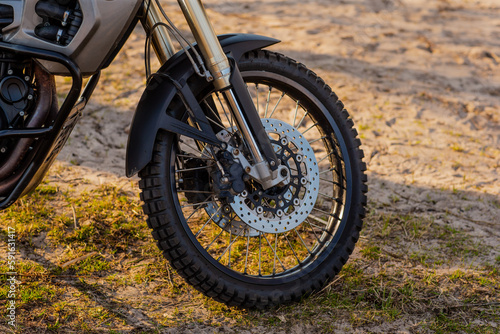 Enduro type motorcycle front wheel side view of disks and brakes