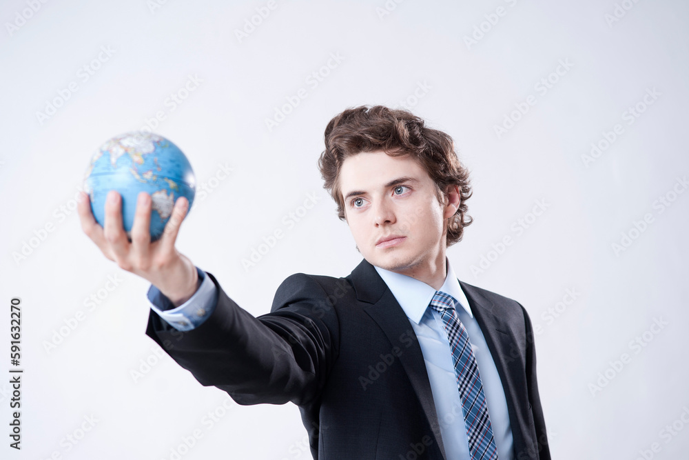 Portrait of Young Businessman holding World Globe Portrait of Young Businessman holding World Globe