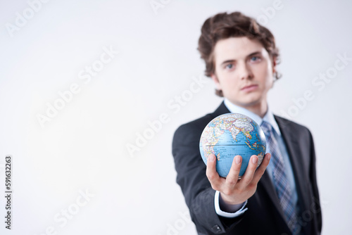 Portrait of Young Businessman holding World Globe photo