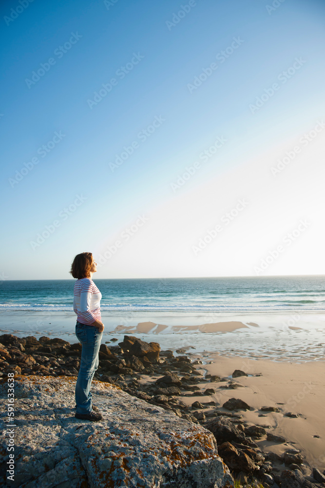 Woman Looking into the Distance at the Beach, Camaret-sur-Mer, Crozon Peninsula, Finistere, Brittany, France Woman Looking into the Distance at the Beach, Camaret-sur-Mer, Crozon Peninsula, Finistere, Brittany, France