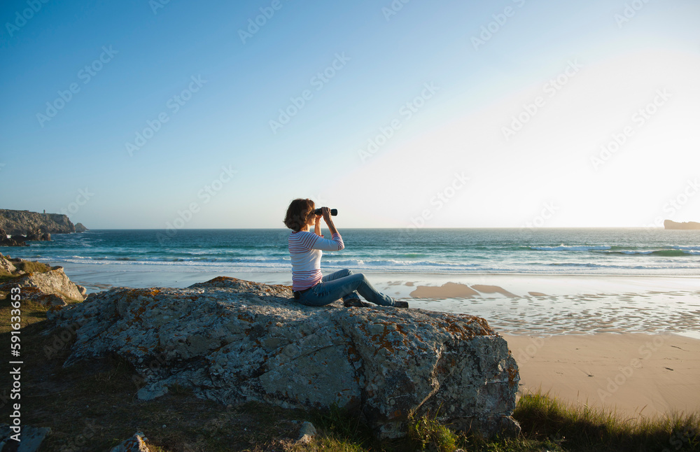 Woman Looking into the Distance Using Binoculars at the Beach, Camaret-sur-Mer, Crozon Peninsula, Finistere, Brittany, France