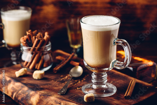 Coffee with Irish whiskey and whipped cream in glass