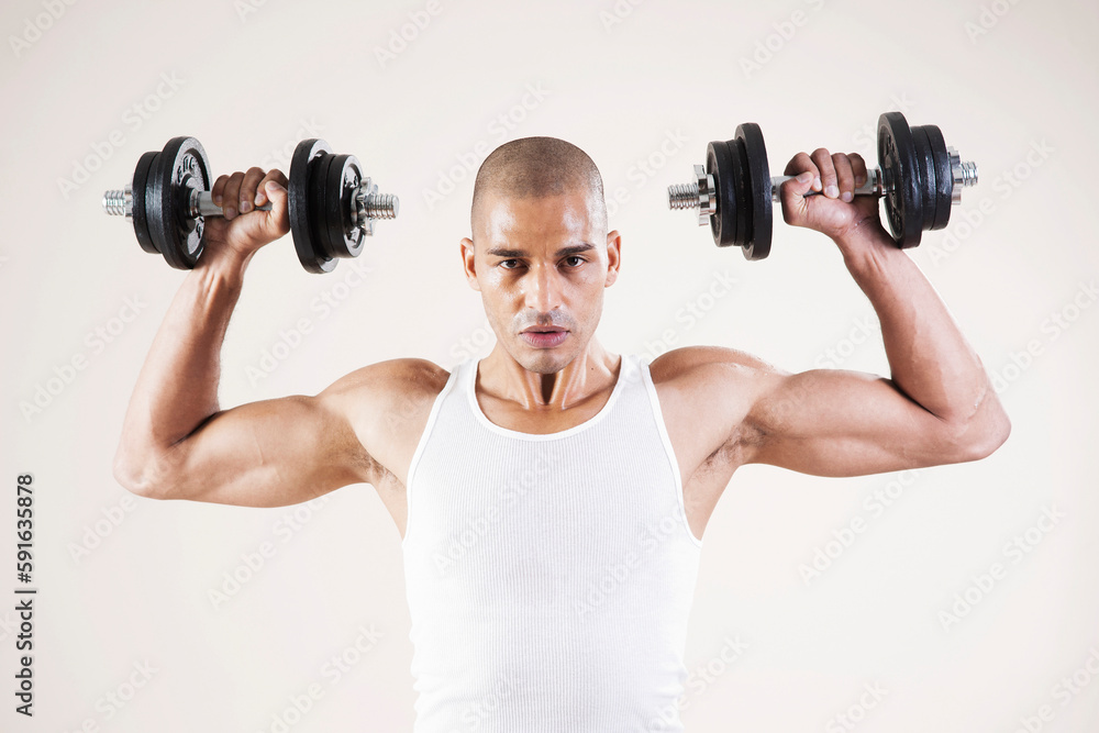 Man Wearing Work Out Clothes and Lifting Weights in Studio with White Background Man Wearing Work Out Clothes and Lifting Weights in Studio with White Background