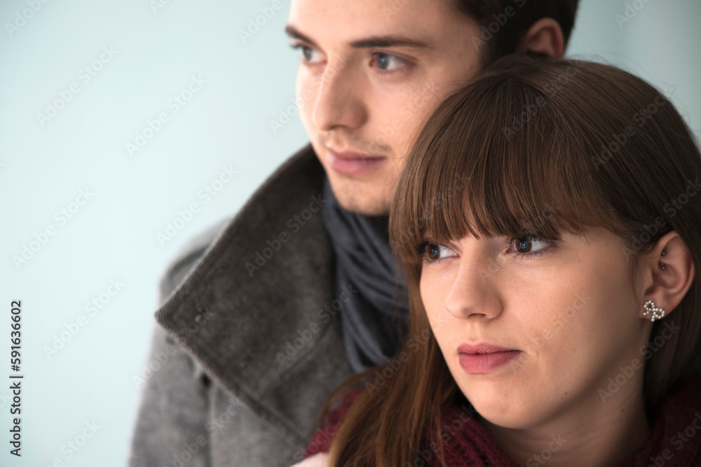 Close-up, Head and Shoulder Portrait of Young Couple Looking to the Side, Studio Shot on Grey Background Close-up, Head and Shoulder Portrait of Young Couple Looking to the Side, Studio Shot on Grey Background