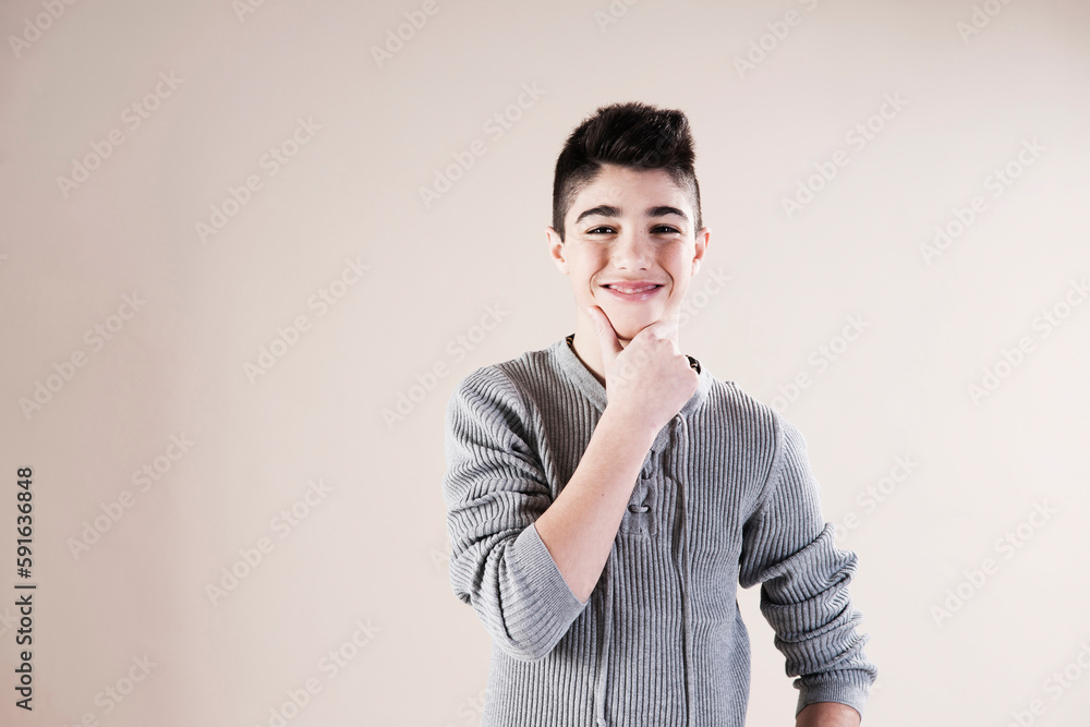 Waist up Portrait of Boy with Hand on Chin in Studio Waist up Portrait of Boy with Hand on Chin in Studio