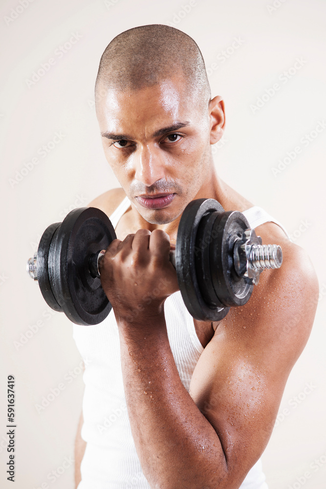 Portrait of Man Looking at Camera, Lifting Barbell Weights doing Bicep Curls, Studio Shot Portrait of Man Looking at Camera, Lifting Barbell Weights doing Bicep Curls, Studio Shot