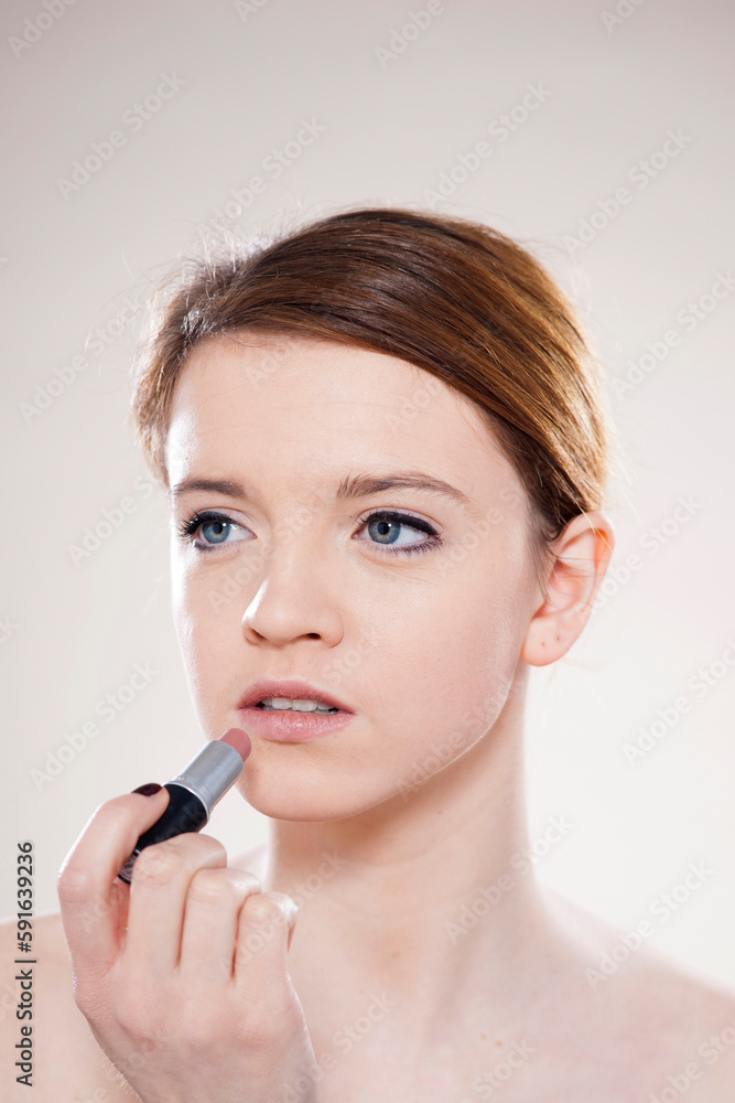 Portrait of Teenage Girl Applying Lipstick in Studio Shot on White Background Portrait of Teenage Girl Applying Lipstick in Studio Shot on White Background