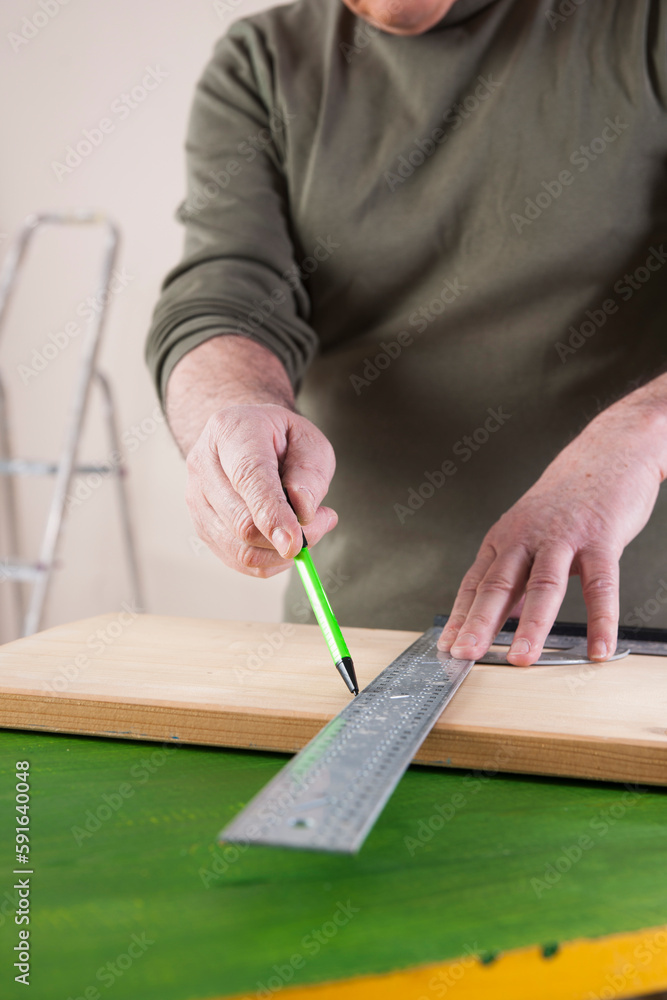 Man Measuring Lumber, Woodworking Project, in Studio Man Measuring Lumber, Woodworking Project, in Studio