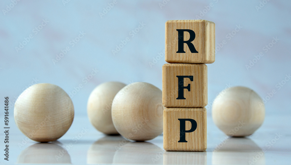 RFP - acronym on wooden cubes on the background of light balls. RFP - acronym on wooden cubes on the background of light balls.