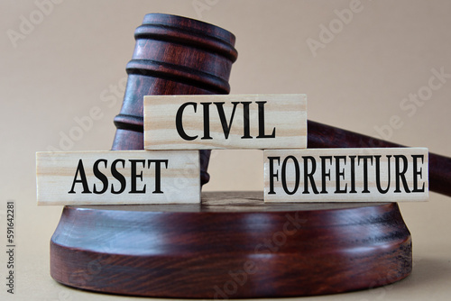 CIVIL ASSET FORFEITURE - words on wooden blocks against the background of a judge's gavel with a stand. photo