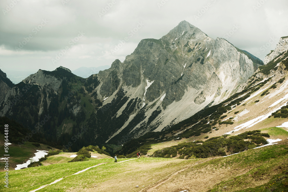 mature-couple-hiking-in-mountains-tannheim-valley-austria-stock-photo