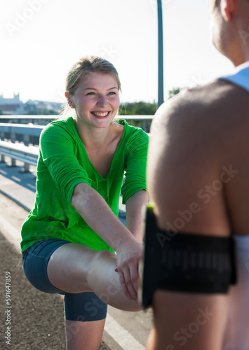 Young Couple Stretching before Running, Worms, Rhineland-Palatinate, Germany photo