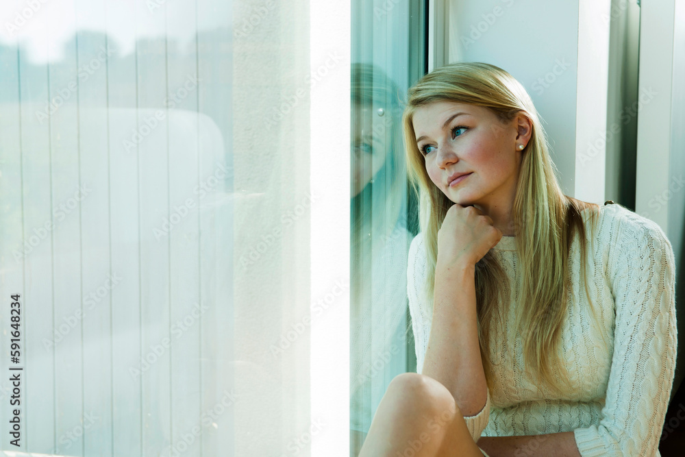 Young Woman Looking out Window, Mannehim, Baden-Wurttemberg, Germany