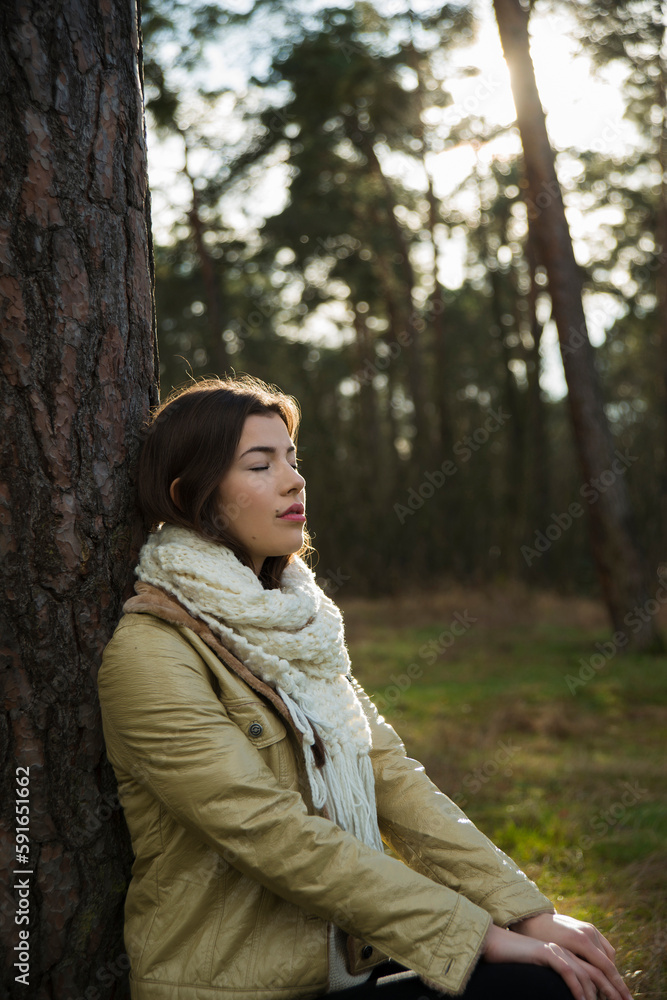 Young Woman Leaning against Tree Trunk, Mannheim, Baden-Wurttemberg, Germany Young Woman Leaning against Tree Trunk, Mannheim, Baden-Wurttemberg, Germany