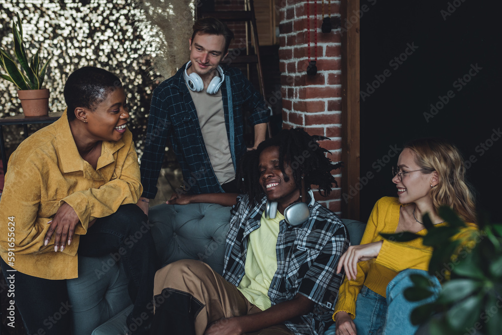 Fototapeta premium Diverse group of young people, friends, college students gathering together, have fun, playing games, laughing. Concept of diversity, international friendship, learning foreign languages, university