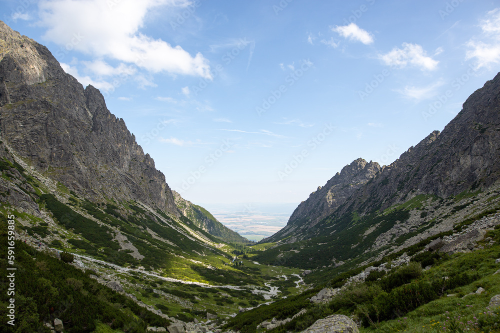 a lush green valley in the Slovakian Hrebienok in the summer with beautiful clouds a lush green valley in the Slovakian Hrebienok in the summer with beautiful clouds