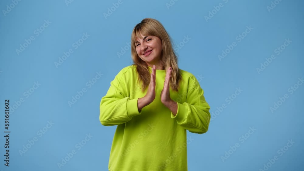 4k video of excited girl clapping in hands on blue background. 4k video of excited girl clapping in hands on blue background.